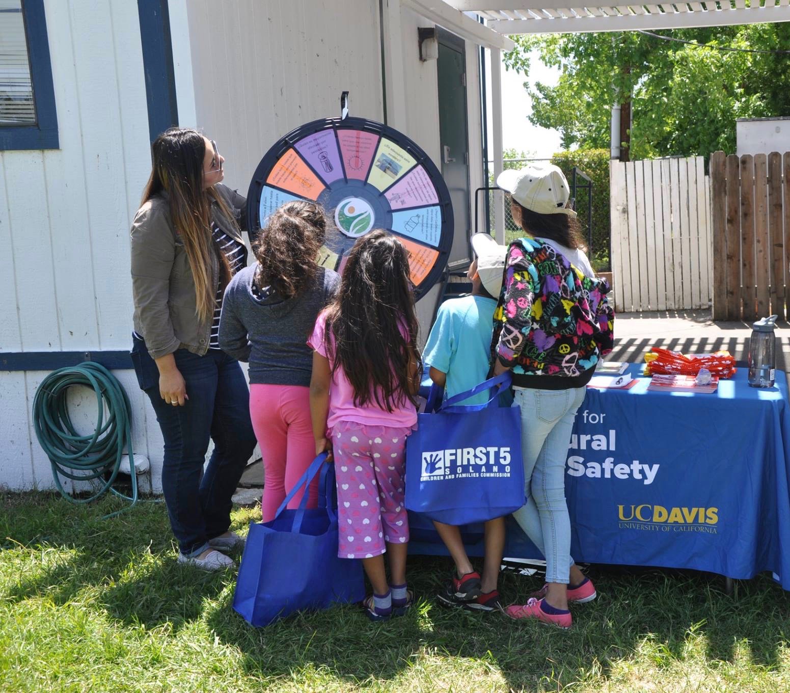 Isabel Flores Garcia talking with children at Dixon Migrant Labor Camp