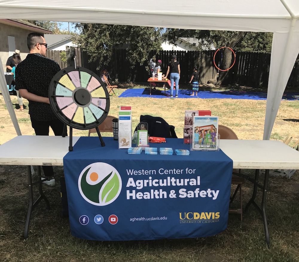 WCAHS table and kids water obstacle course in background