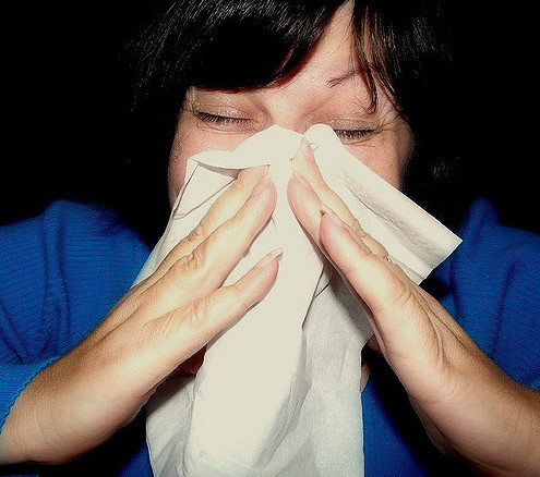 Woman sneezing