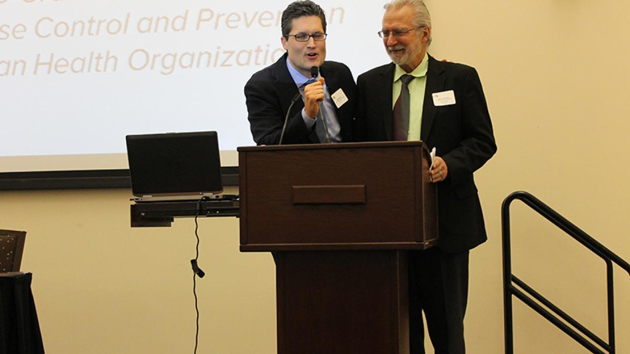 Conference organizers Giovanni Peri (Migration Research Cluster) and Marc Schenker (Migration & Health Research Center) thank MLGH participants. 
