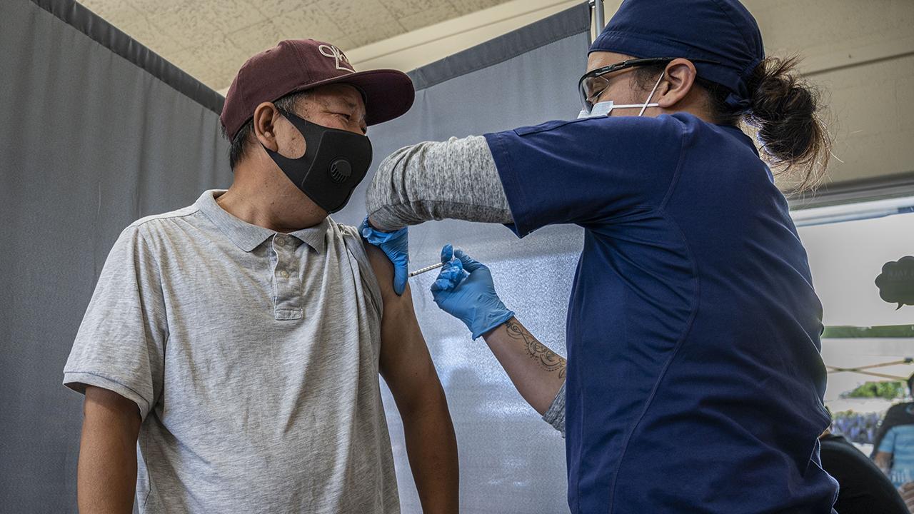 Man receiving COVID-19 vaccine in his upper arm
