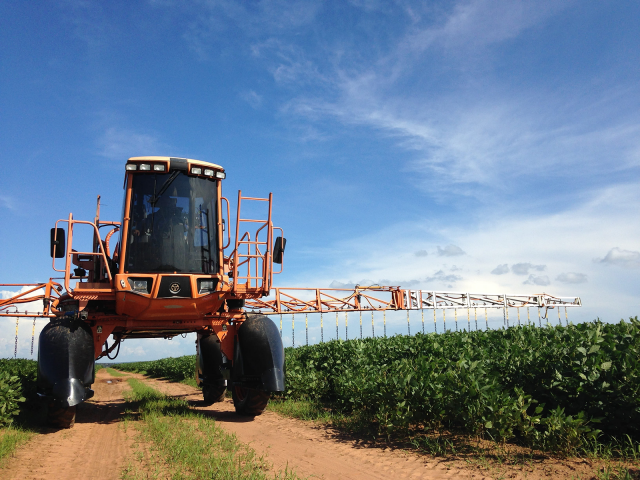 Agricultural equipment sprays pesticides in the field