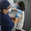 A woman receives a COVID-19 vaccine at a clinic