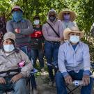 Farmworkers rest in the shade for a training