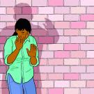 Illustration of woman up against a brick wall with the shadow of a man over her